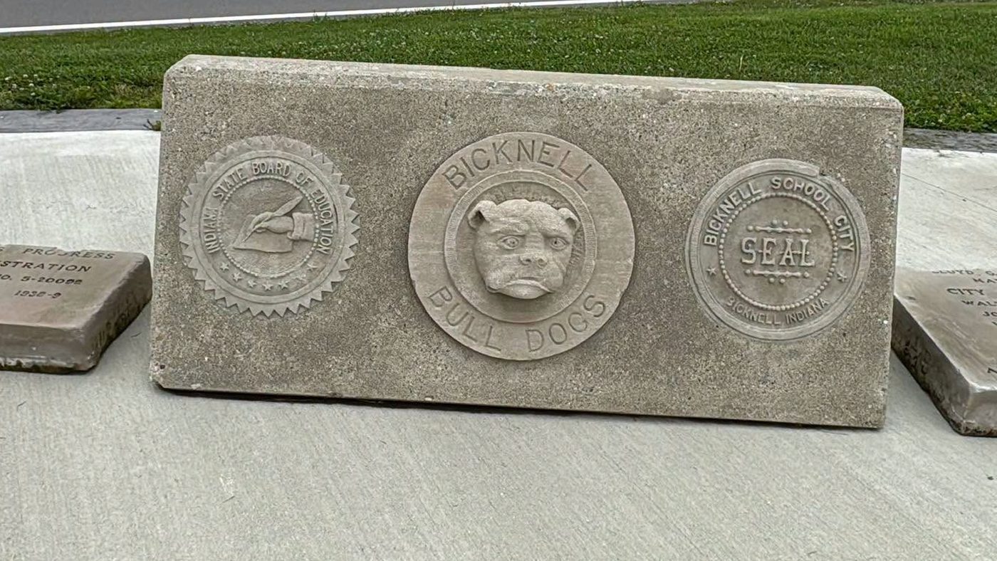 Carved limestone from the former Bicknell school, showing the Bicknell Bulldogs and the Bicknell School City seal